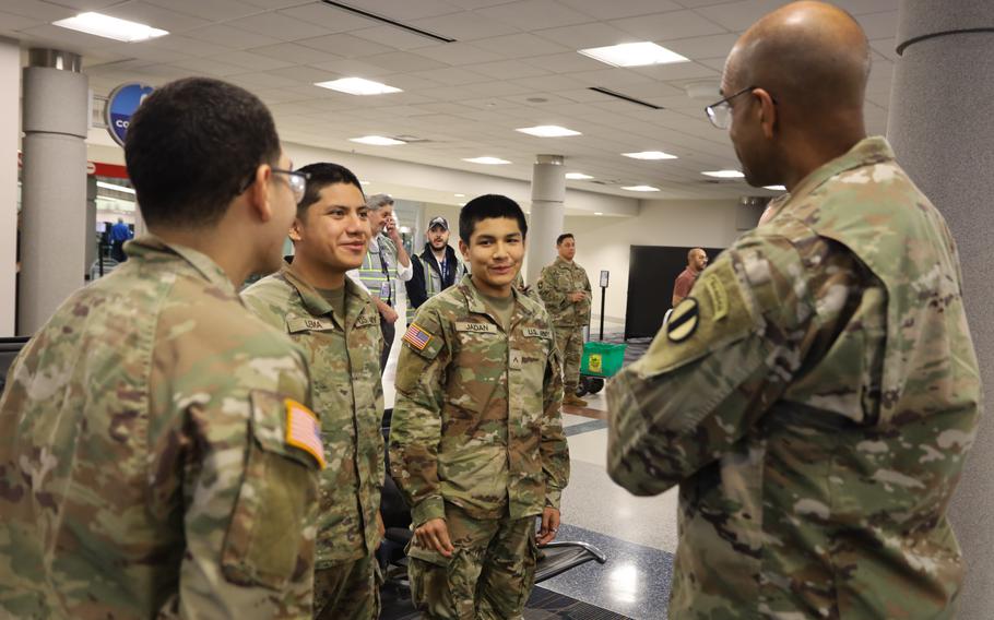 Gen. Gary Brito talks with three soldiers 