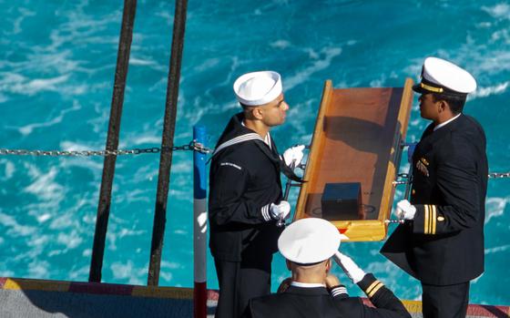 Sailors prepare to lay to rest the remains of former Navy junior officer Marc Rockwell-Pate, Sept. 30, 2024, during a burial at sea aboard the aircraft carrier USS Ronald Reagan while underway in the U.S. 3rd Fleet area of operations in the Pacific Ocean.