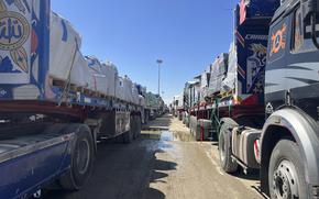 Aid trucks in two lines are blocked from entry into Gaza,