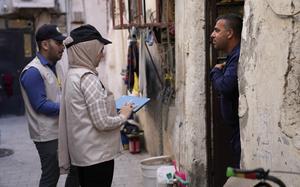 Two Iraqi government workers stand by someone’s door to collect information for the country’s census, Baghdad, Iraq, Nov. 20, 2024. 