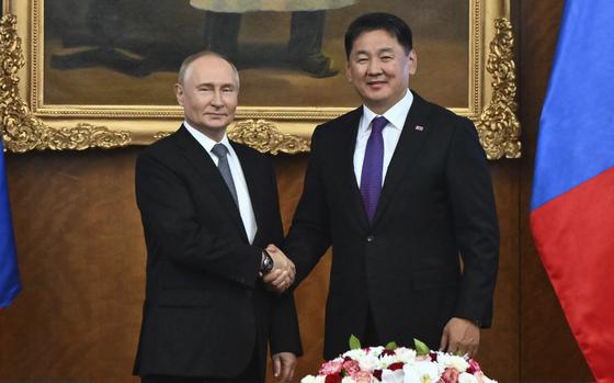 Russian President Vladimir Putin, left and Mongolian President Ukhnaagiin Khurelsukh shake hands prior to talks in Ulaanbaatar, Mongolia, on Sept. 3, 2024.