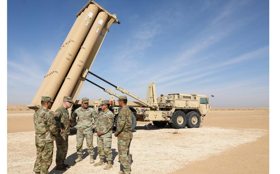 A U.S. Army Terminal High Altitude Area Defense (THAAD) crew next to a launcher.