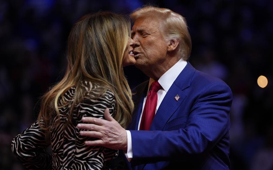 Donald Trump embraces Melania Trump at a campaign rally. 