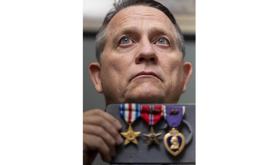 Veteran James McCormick holds his medals.