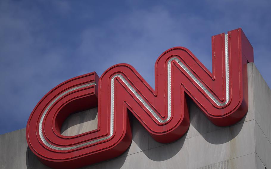 A closeup of the CNN logo, seen on the corner of a building.