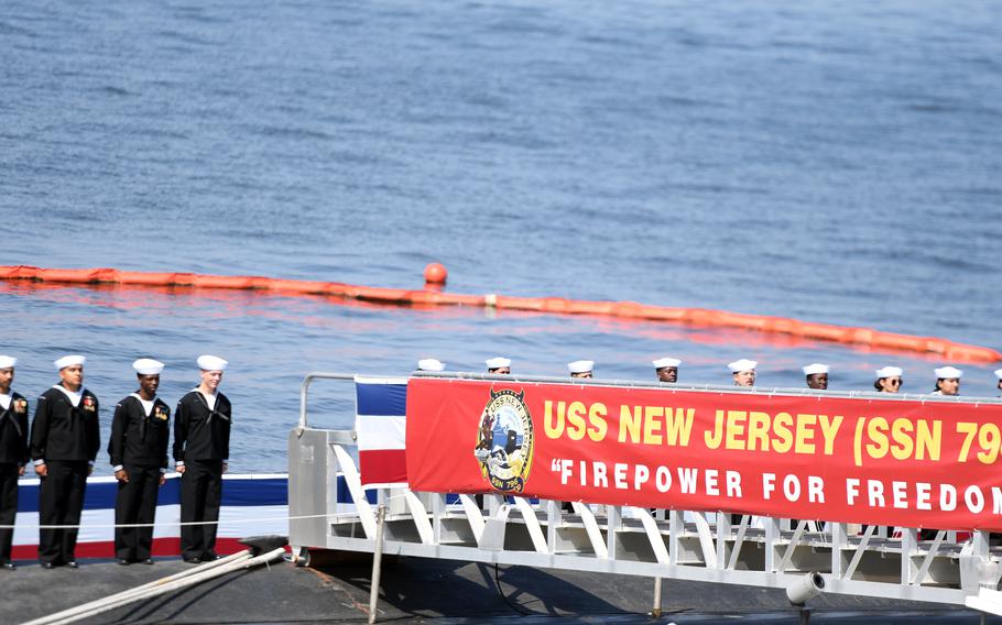 Sailors ceremonially man their ship