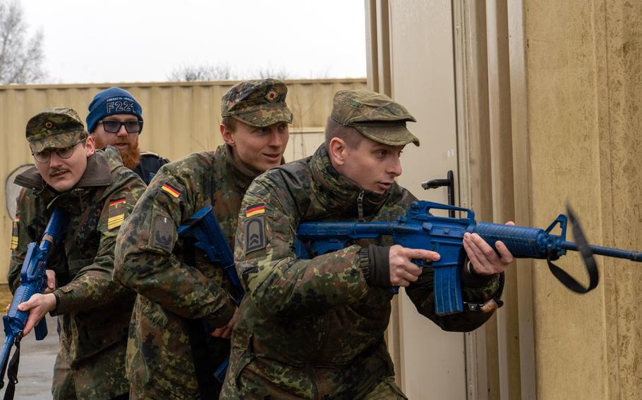 German soldiers hold practice rifles