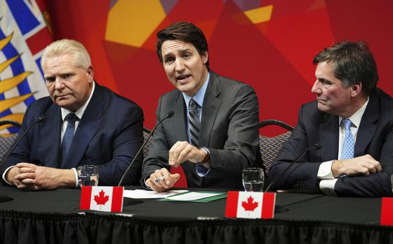 Ontario Premier Doug Ford, left, and Intergovernmental Affairs Minister Dominic Leblanc, right, look on as Canada's Prime Minister Justin Trudeau speaks at a press conference concluding a first ministers meeting, in Ottawa, Ontario, Wednesday, Jan. 15, 2025. (Sean Kilpatrick/The Canadian Press via AP)