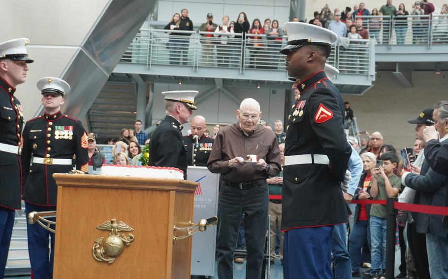 Staff Sgt. Al Ullman, 91, is presented a piece of cake by Col. (Ret.) Keil Gentry