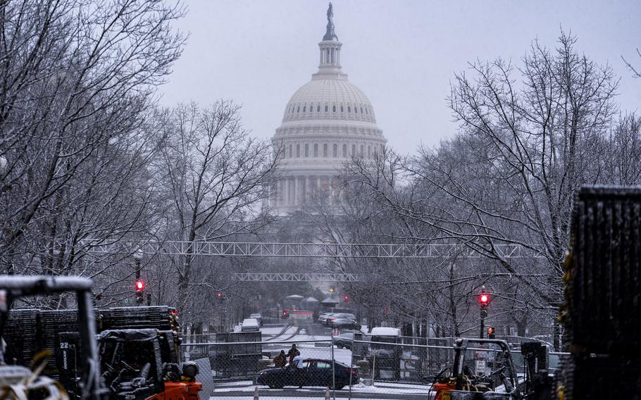 Snow falls on the Capitol in Washington.