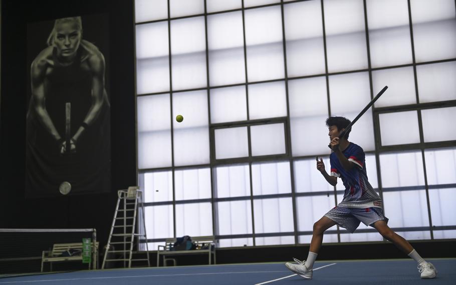 Ramstein’s Eric Kim steps forward, poised to strike the ball, as he competes in a doubles match alongside his brother, Sean Kim, against Naples’ Kai Barania and Tavi Shah during the DODEA European tennis championships at T2 Sports Health Club in Wiesbaden, Germany, on Oct. 21, 2023.