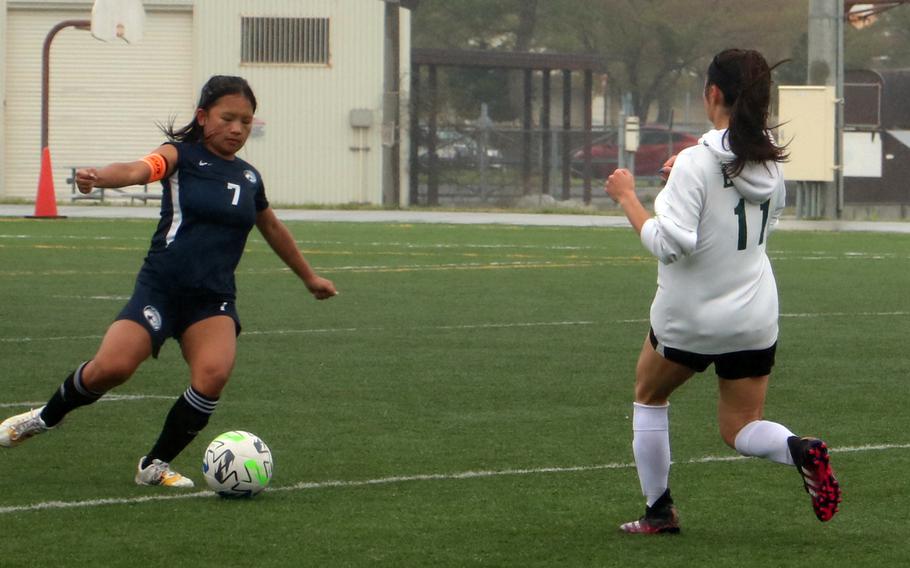Osan’s Jazmine Butalina dribbles against Edgren’s Leilani Huntington during Tuesday’s girls Division II soccer playoff. The Eagles won 1-0, their first victory in 19 tries this season.