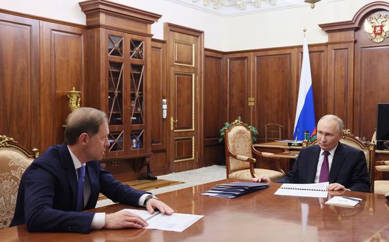 In this pool photograph distributed by the Russian state agency Sputnik, Russia's President Vladimir Putin meets with Russian First Deputy Prime Minister Denis Manturov at the Kremlin in Moscow on Nov. 20, 2024. (Vyacheslav Prokofyev/Pool/AFP/Getty Images/TNS)