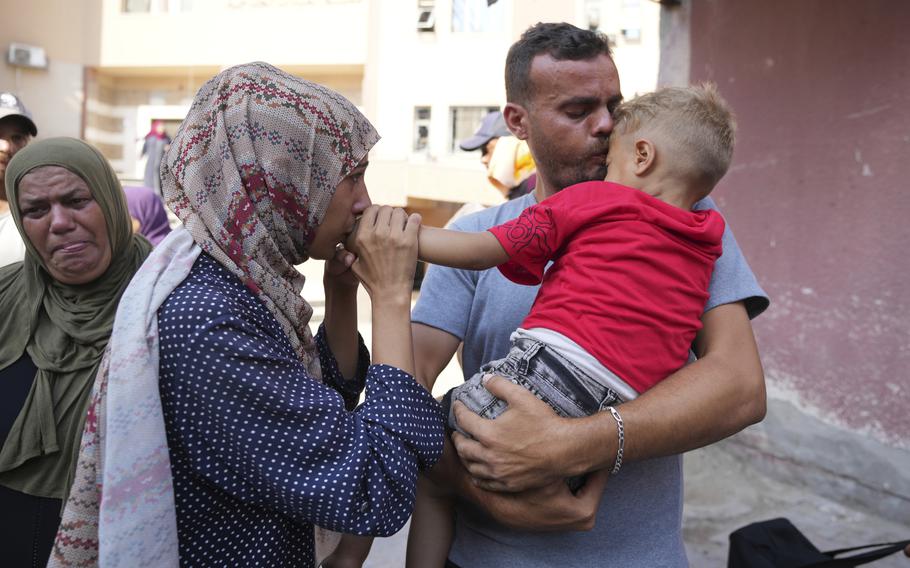 A Palestinian couple says goodbye to their sick son before leaving the Gaza Strip to get treatment abroad on June 27, 2024.