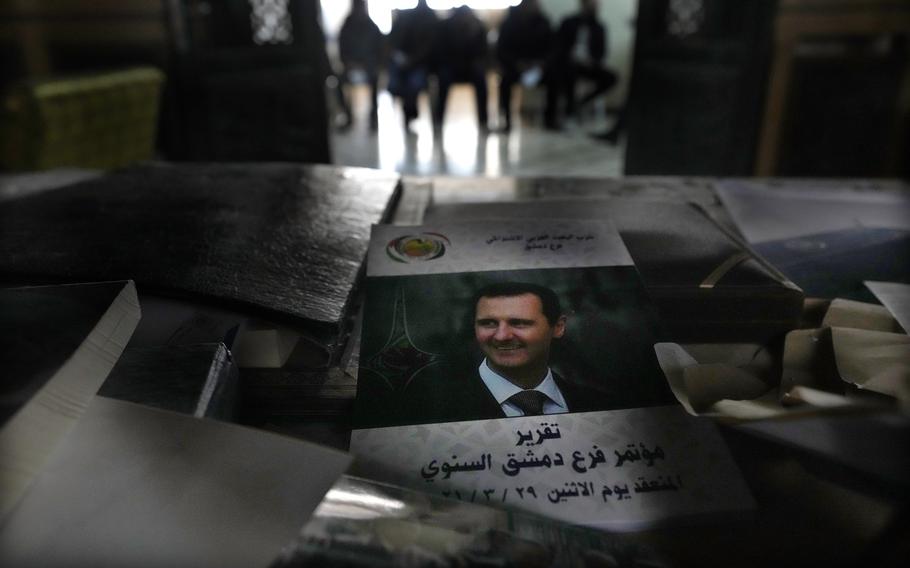 A picture of ousted Syrian President Bashar Assad is placed on a desk.