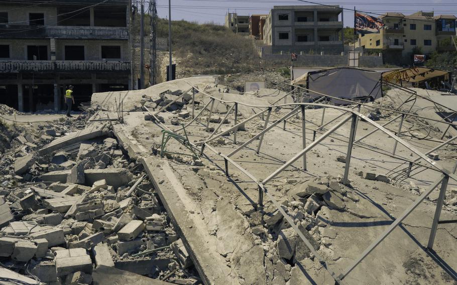 A member of Lebanon’s civil defense force walks near the site of a strike in June on the town of Wadi Jilo in southern Lebanon on Aug. 4, 2024. 