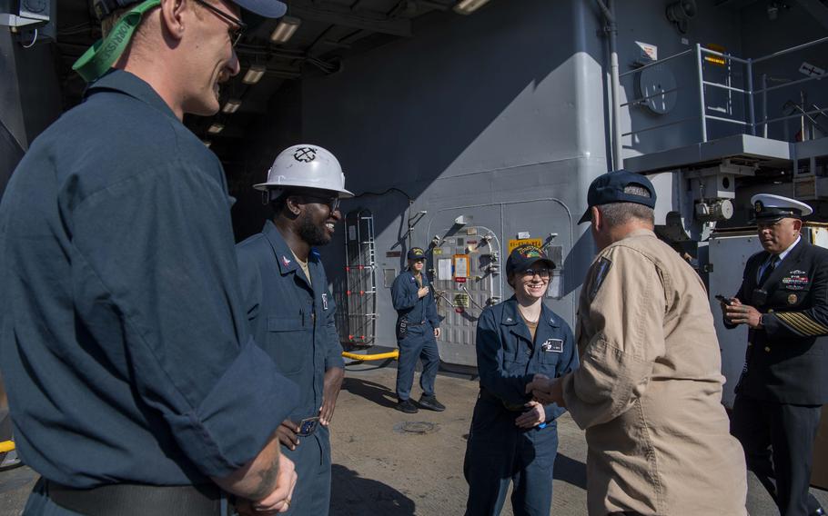 Rear Adm. Ted LeClair, deputy commander, Naval Surface Forces, U.S. Pacific Fleet, speaks with Engineman 2nd Class Shelby Smith