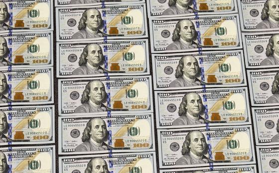 U.S. currency in one hundred dollar denominations are displayed for illustration purposes, in Washington, Monday, March 31, 2014. (AP Photo/J. Scott Applewhite)