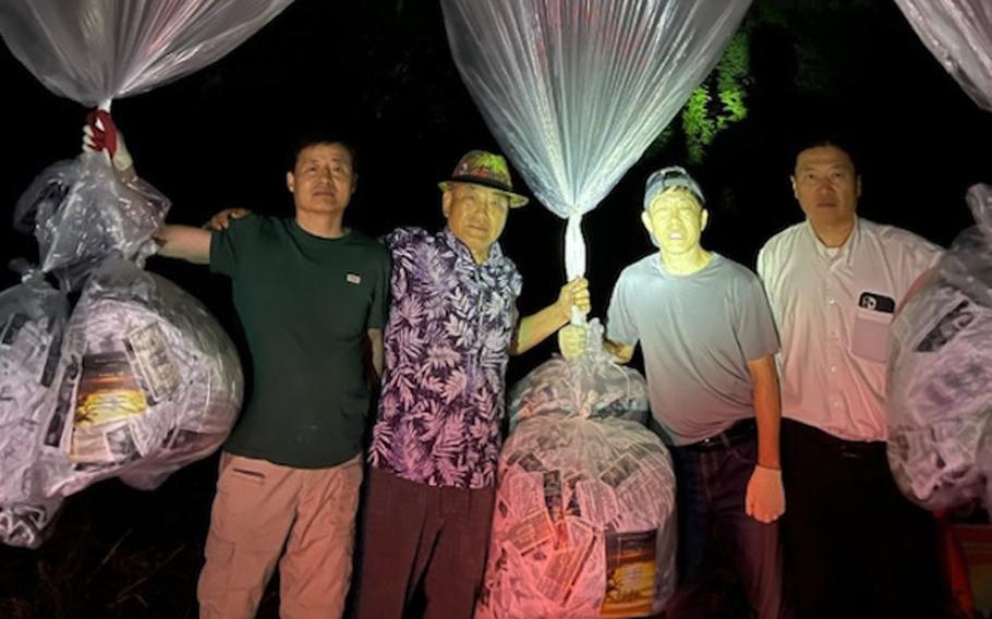 South Korean activists pose before sending balloons to North Korea from an undisclosed location, June 6, 2024. 