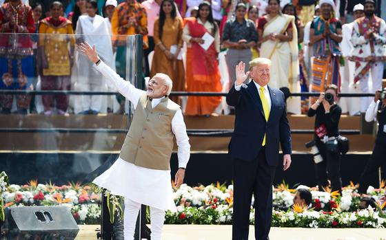 On Feb. 24, 2020, U.S. President Donald Trump, right, and India's Prime Minister Narendra Modi wave at the crowd during 'Namaste Trump' rally at Sardar Patel Stadium in Motera, on the outskirts of Ahmedabad, India. (Money Sharma/AFP/Getty Images/TNS)