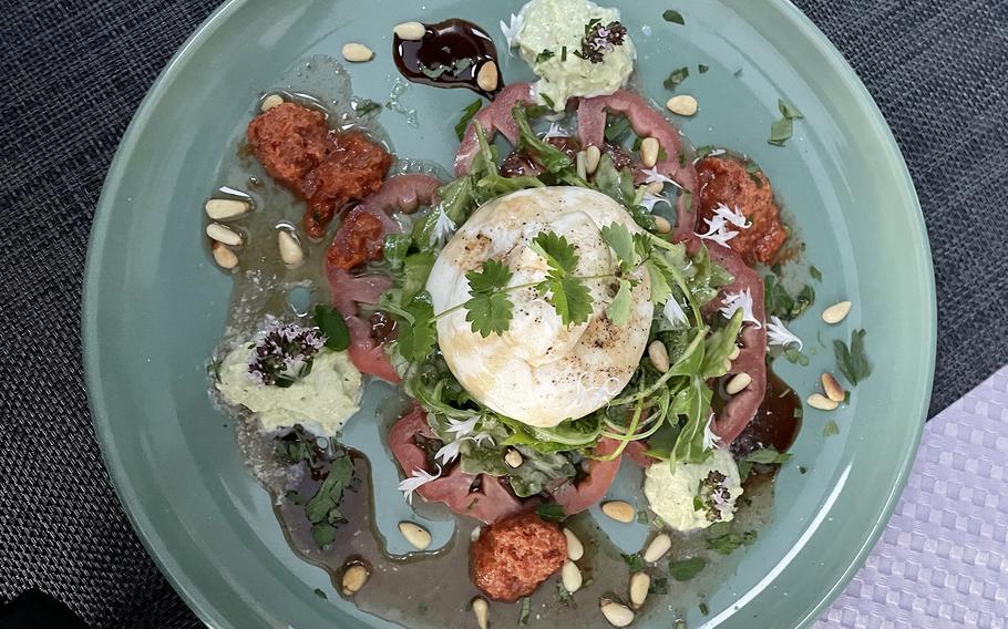 This appetizer at Markers Kleines Restaurant in Weilerbach, Germany, was a thinly sliced oxheart tomato topped with burrata and arugula and garnished with basil foam and tomato sherbet. Burrata is a cheese made from mozzarella and cream.