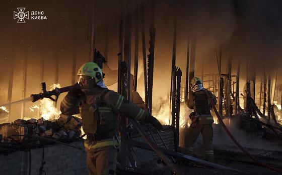 In this photo provided by the Ukrainian Emergency Service on Thursday, Nov. 7, 2024, rescuers put out a fire of a building which was resulted from Russian drone attack in Kyiv, Ukraine. (Ukrainian Emergency Service via AP)