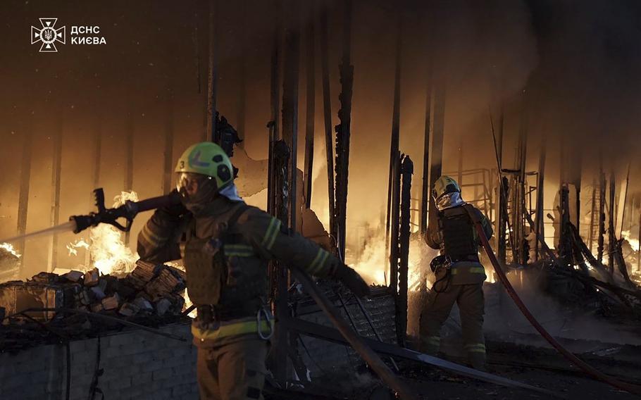 Rescuers put out a fire of a building