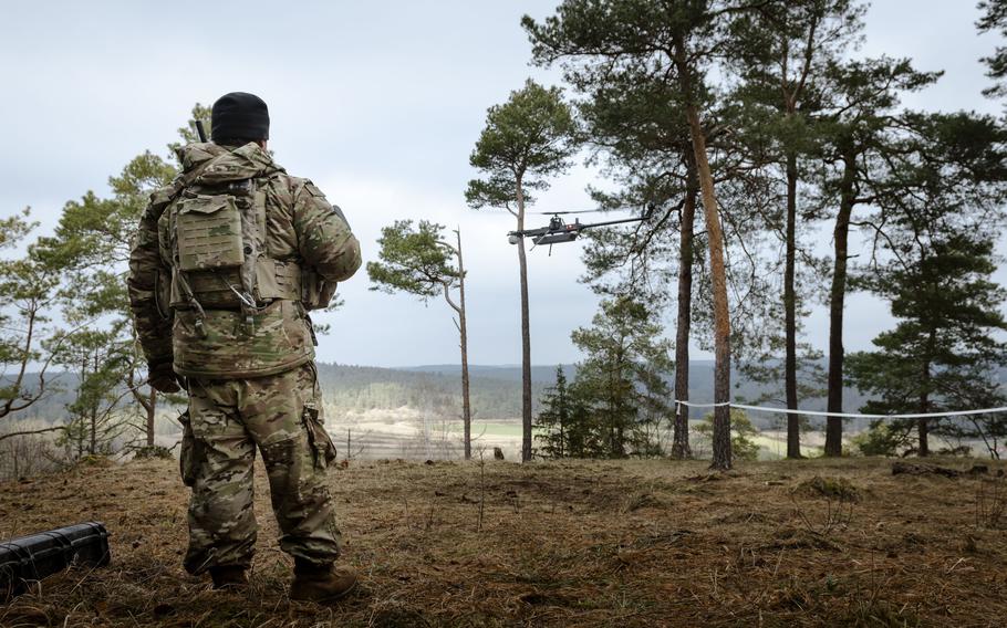 A U.S. soldier watches a drone land.