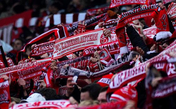 Fans hold up their team scarves during a 1. FC Kaiserslautern home game at Fritz Walter Stadium.