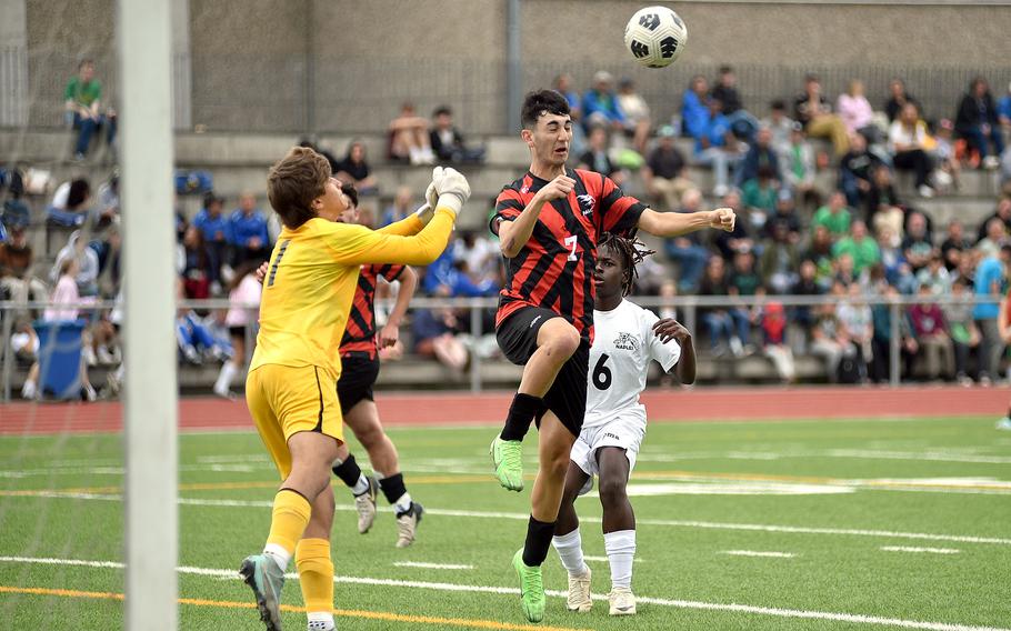 American Overseas School of Rome winger Valerio Di Cesare heads a free kick ahead of Naples goalkeeper Joey Randazzo during the Division II title match at the DODEA European soccer championships on May 23, 2024, at Ramstein High School on Ramstein Air Base, Germany.