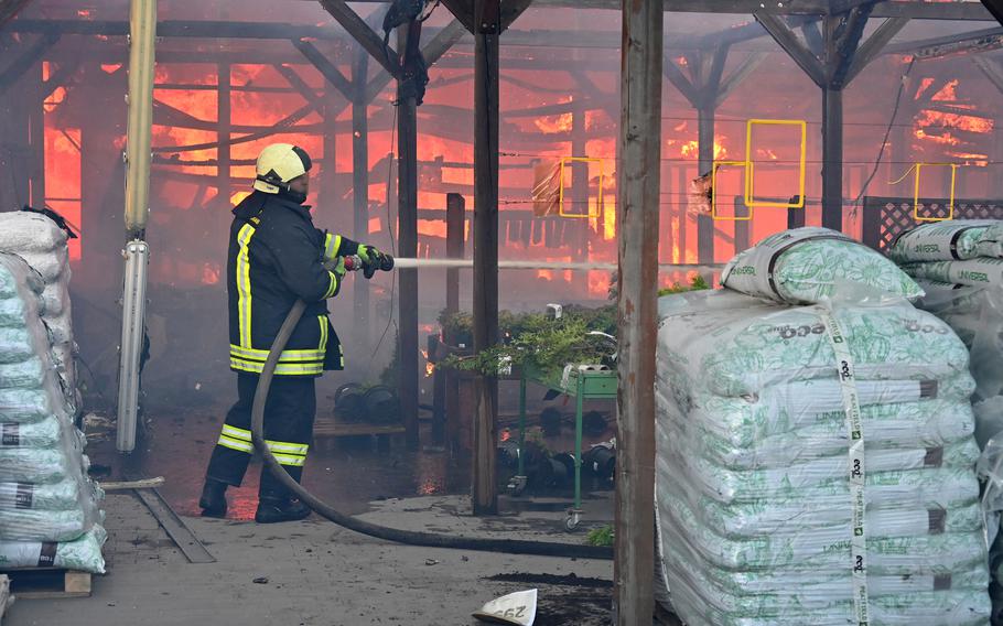 A Ukrainian firefighter intervenes to extinguish a fire at a hardware superstore following a Russian strike, in Kharkiv, on May 25, 2024.