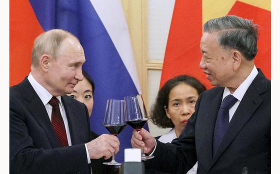 In this pool photograph distributed by the Russian state agency Sputnik, Russia's President Vladimir Putin (left) and Vietnam's President To Lam (right) toast during a reception at the Hanoi Opera House in Hanoi on June 20, 2024. Russia and Vietnam pledged on June 20, 2024, to deepen ties as President Vladimir Putin made a state visit aimed at bolstering his alliances to counter Moscow's growing isolation over the war in Ukraine. (Gavriil Grigorov/Pool/AFP via Getty Images/TNS)