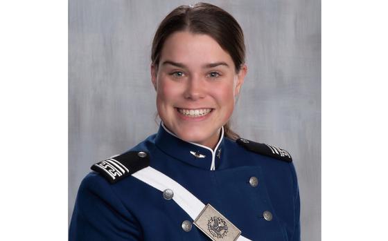 A woman smiles for the camera in her Air Force Academy cadet uniform.