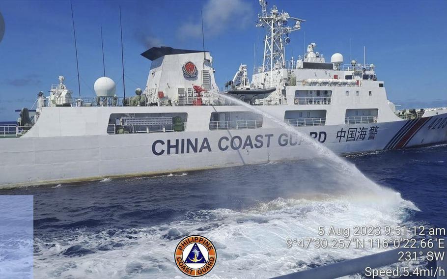 A Chinese coast guard ship uses water cannons on a Philippine Coast Guard ship near the Philippine-occupied Second Thomas Shoal in the South China Sea in August 2023.