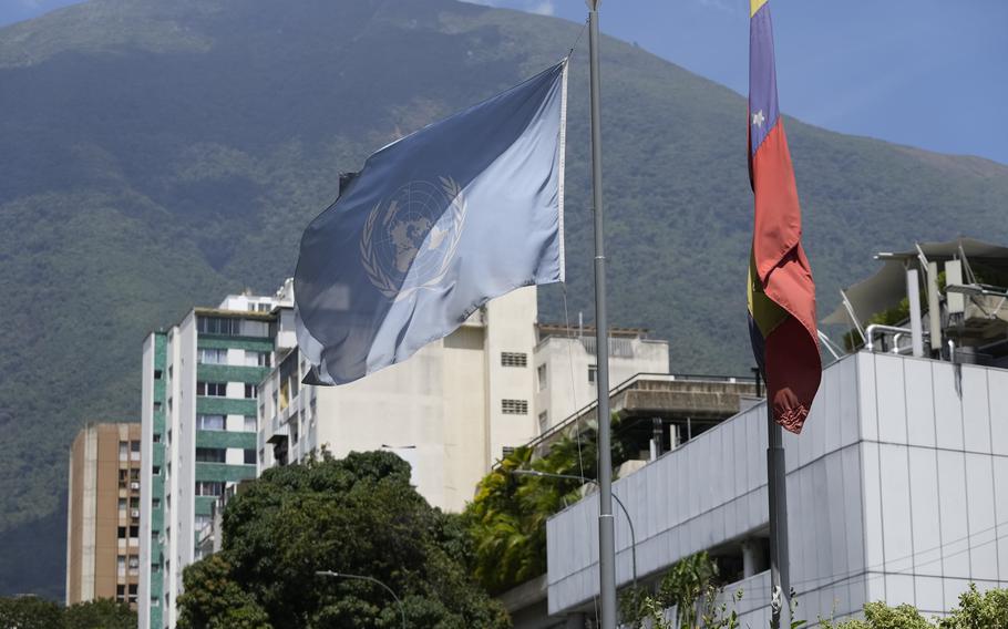 U.N. and Venezuelan flags hang outside the building that houses the Technical Advisory Office of the United Nations High Commissioner for Human Rights, in Caracas, Venezuela, Feb. 15, 2024.