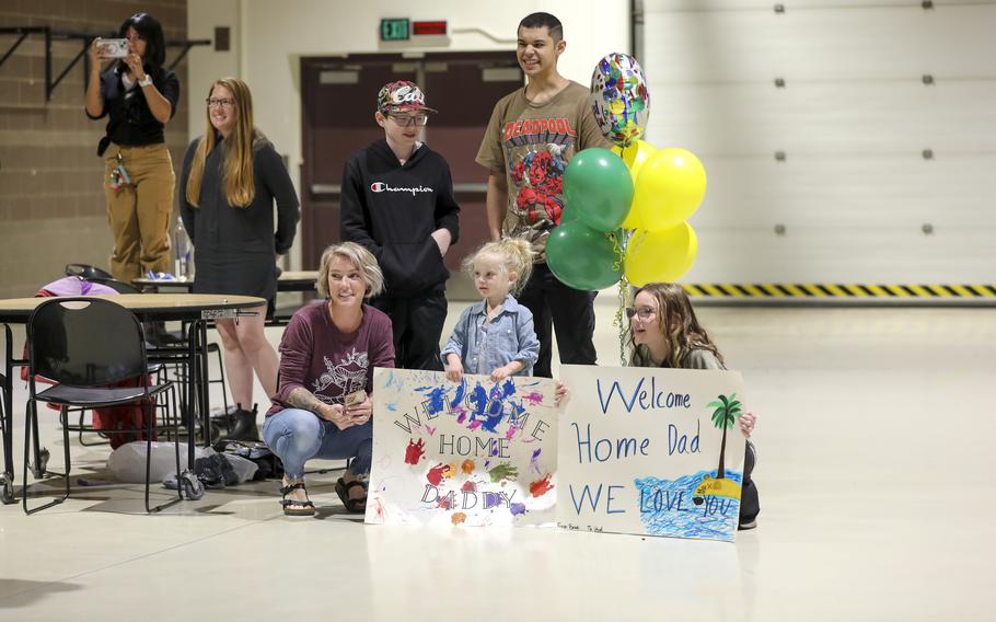 Friends and family members wait to reunite with their Alaska Army National Guardsmen during a welcome home event at the Alaska National Guard Readiness Center on Joint Base Elmendorf-Richardson, Aug. 10, 2024. 