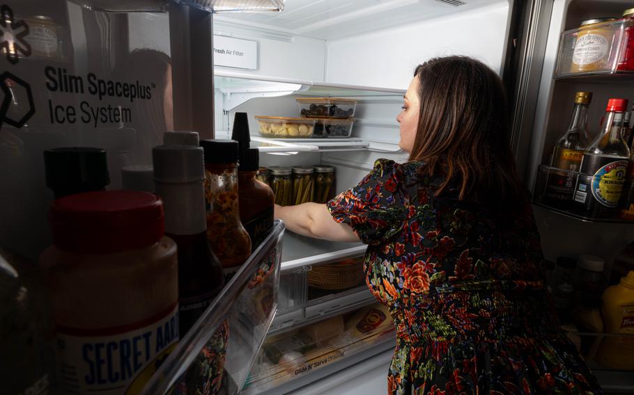 Lynzi Judish restocks her refrigerator with all the trappings. 