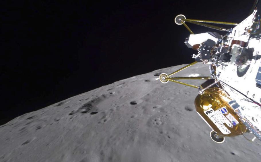 The lunar lander approaches the surface of the moon with the deep black of space in the background.