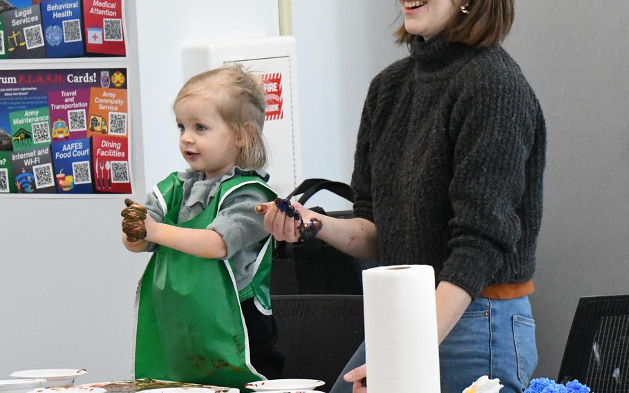 Fort Drum family members work on a sensory art project inside on March 1, 2024, during the monthly sensory workshop. Hosted by the Fort Drum Exceptional Family Member Program, the monthly workshop helps community members better understand sensory processing and how it can affect behaviors.