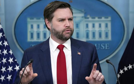 Vice President JD Vance speaks with both hands raised, index fingers pointing out.