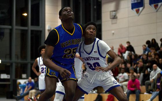 Wiesbaden's Joel Idowu and Ramstein's Amari Guishard battle under the basket during a Dec. 17, 2024, game at Ramstein High School on Ramstein Air Base, Germany.