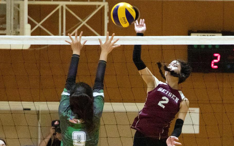 Seisen International's Naomi Terashima spikes against Kubasaki's Madison Nguyen during Thursday's American School In Japan YUJO Tournament match. The Dragons won in three sets.