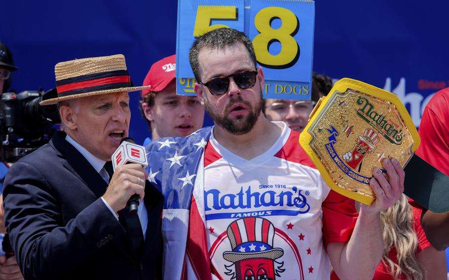 Patrick Bertoletti celebrates after winning the men's compeition in Nathan's Famous Fourth of July hot dog eating contest at Coney Island.
