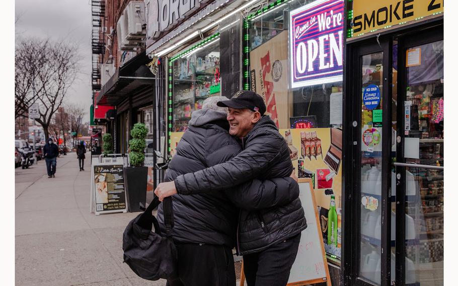An old friend runs into Jose Marquez for the first time since Marquez returned to the United States, outside a bodega near his home in New York. 