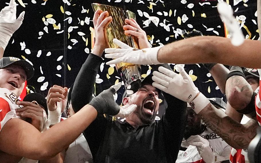 Confetti falls as Ryan Day and Buckeyes players celebrate.