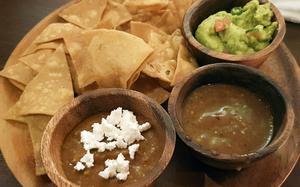 Appetizers at Kuma Cantina in Tokyo include chips with guacamole, salsa and bean dip.