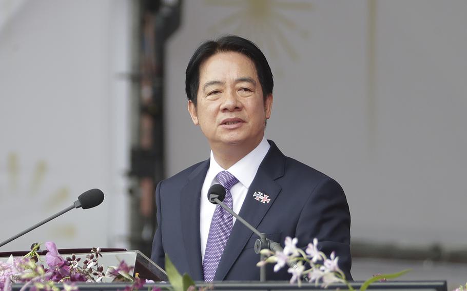 The Taiwanese president speaks in front of flowers and microphones in Taiwan.