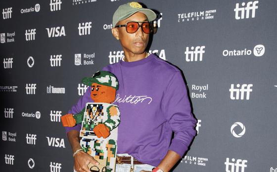 Pharrell Williams arrives on the red carpet for the premiere of “Piece by Piece” at the Princess of Wales Theatre during the Toronto International Film Festival, Sept. 10. He attended with a 2-foot-tall Lego sculpture of himself, as the music biopic is animated with Legos. 