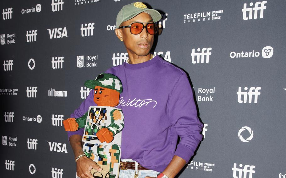 Pharrell Williams arrives on the red carpet for the premiere of “Piece by Piece” at the Princess of Wales Theatre during the Toronto International Film Festival, Sept. 10. He attended with a 2-foot-tall Lego sculpture of himself, as the music biopic is animated with Legos. 