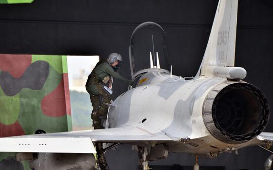 A Taiwan air force pilot climbs out of a Mirage 2000 fighter jet after a flight over Hsinchu Air Base, Taiwan, Jan. 11, 2022. 